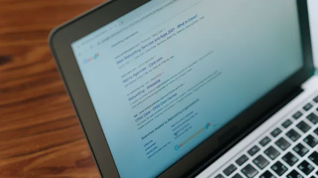 A close-up view of a laptop displaying a search engine page.